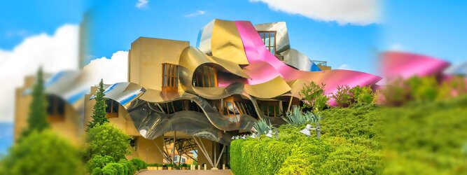 Trip Reiseideen Reisetipps - Marqués de Riscal Design Hotel, Bilbao, Elciego, Spanien. Fantastisch galaktisch, unverkennbar ein Werk von Frank O. Gehry. Inmitten idyllischer Weinberge in der Rioja Region des Baskenlandes, bezaubert das schimmernde Bauobjekt mit einer Struktur bunter, edel glänzender verflochtener Metallbänder. Glanz im Baskenland - Es muss etwas ganz Besonderes sein. Emotional, zukunftsweisend, einzigartig. Denn in dieser Region, etwa 133 km südlich von Bilbao, sind Weingüter normalerweise nicht für die Öffentlichkeit zugänglich.